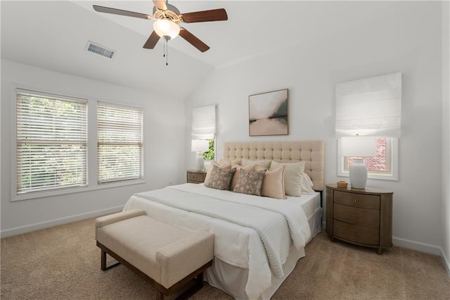 bedroom with baseboards, vaulted ceiling, light colored carpet, and visible vents
