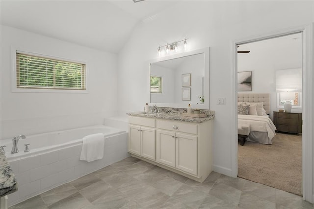 ensuite bathroom with a garden tub, tile patterned flooring, vanity, lofted ceiling, and connected bathroom