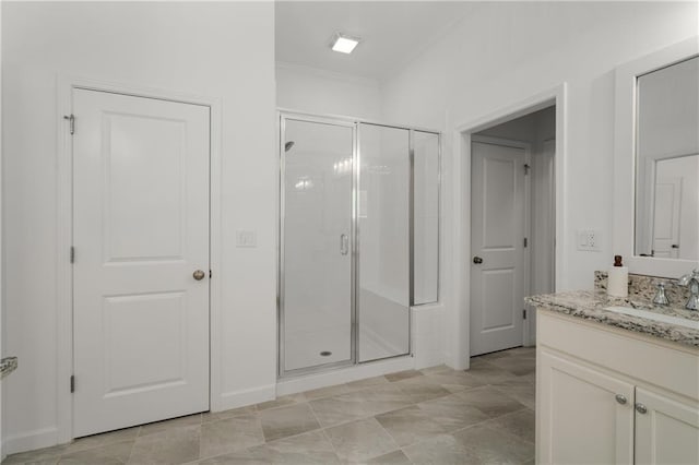 full bathroom with crown molding, a shower stall, and vanity