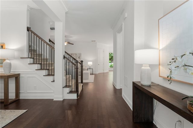 foyer entrance with a ceiling fan, baseboards, dark wood-type flooring, visible vents, and stairway