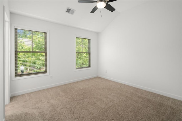 unfurnished room featuring carpet, a ceiling fan, baseboards, lofted ceiling, and visible vents
