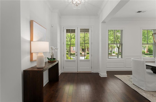 doorway to outside with ornamental molding, dark wood-style flooring, and visible vents