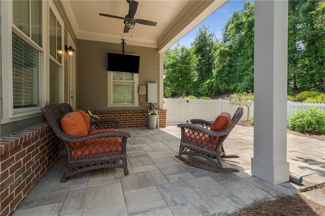view of patio featuring fence and a ceiling fan