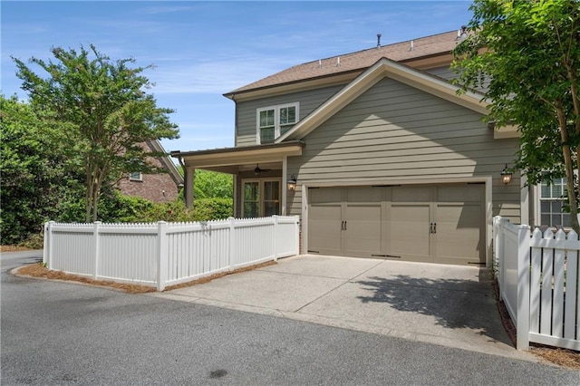 view of front of home with fence and driveway
