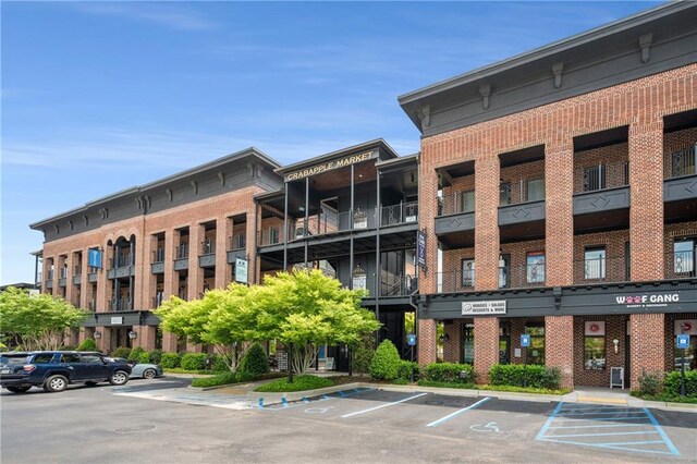 view of building exterior with uncovered parking
