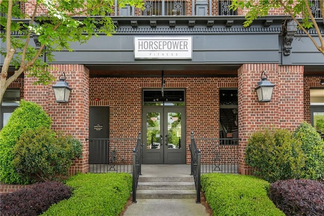 property entrance with brick siding and french doors