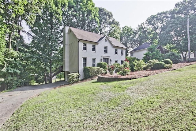 colonial-style house with a front lawn