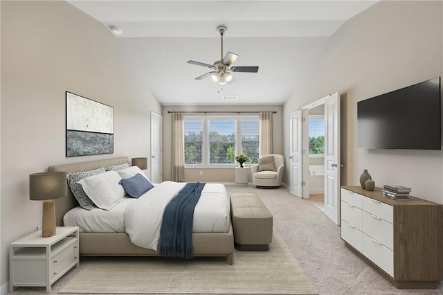 bedroom featuring light colored carpet, lofted ceiling, baseboards, and visible vents