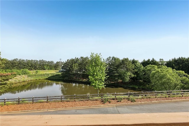 property view of water featuring fence