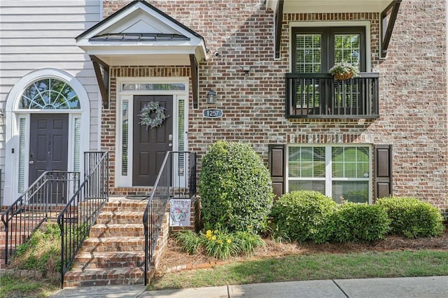 entrance to property featuring brick siding