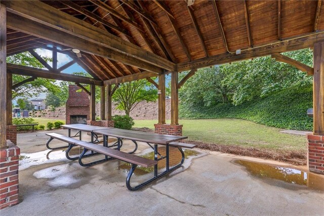 view of patio featuring a gazebo and an outdoor fireplace