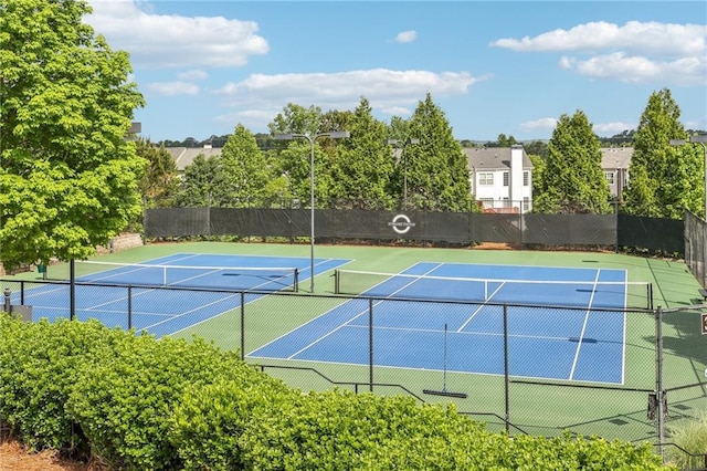 view of tennis court with fence and community basketball court