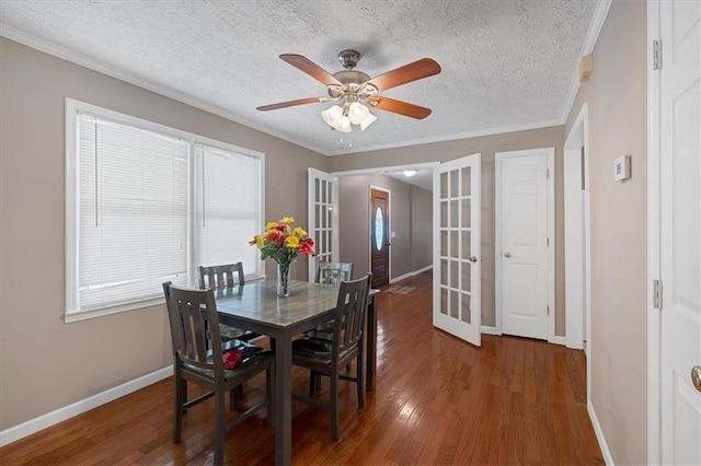 dining space with a healthy amount of sunlight, dark hardwood / wood-style flooring, a textured ceiling, and french doors