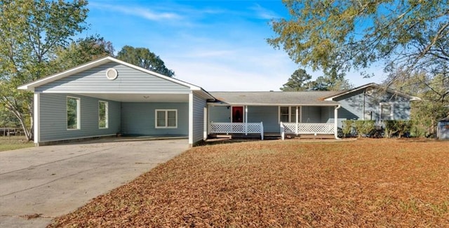 ranch-style home featuring a carport and a porch