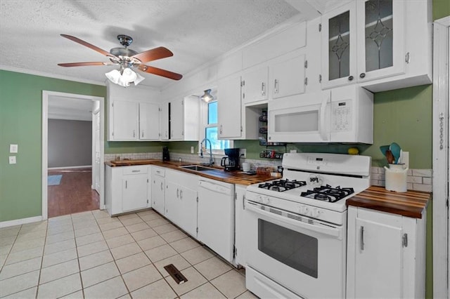 kitchen featuring white cabinets, butcher block counters, white appliances, and sink