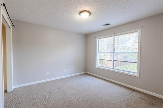 335 Wilma Ct SW, Atlanta, GA 30331 - carpeted spare room featuring baseboards and a textured ceiling