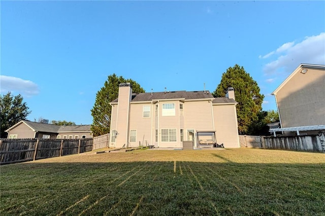 335 Wilma Ct SW, Atlanta, GA 30331 - rear view of house with a fenced backyard and a chimney