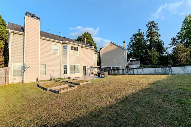 335 Wilma Ct SW, Atlanta, GA 30331 - rear view of house featuring a garden, a chimney, and a patio