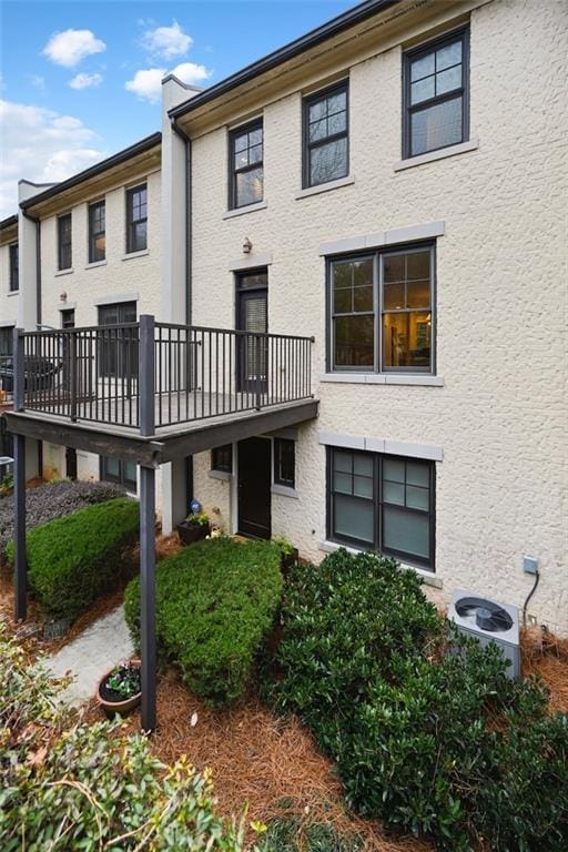 back of house featuring central AC