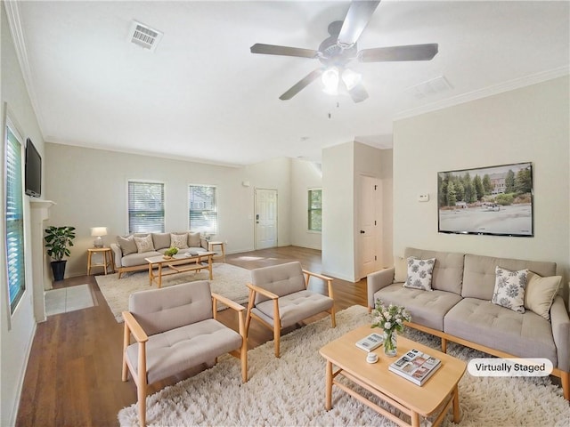 living room featuring ceiling fan, crown molding, and light hardwood / wood-style flooring