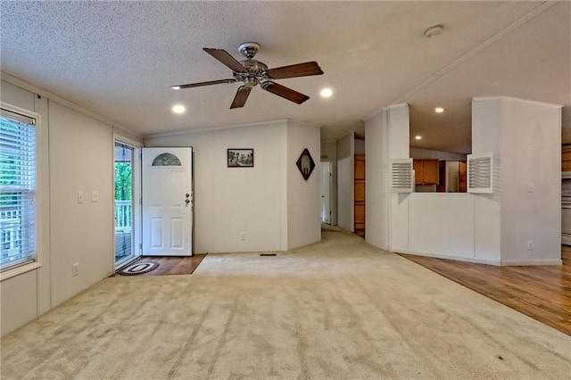 entryway featuring a ceiling fan, recessed lighting, ornamental molding, carpet, and wood finished floors
