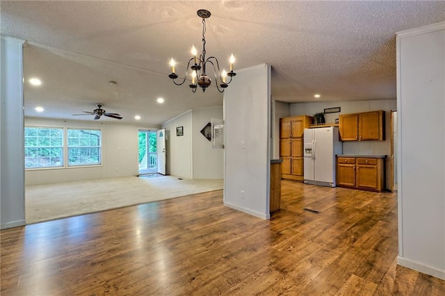 unfurnished living room featuring recessed lighting, a textured ceiling, wood finished floors, a chandelier, and ceiling fan