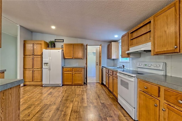 kitchen with white appliances, under cabinet range hood, open shelves, dark wood finished floors, and brown cabinets