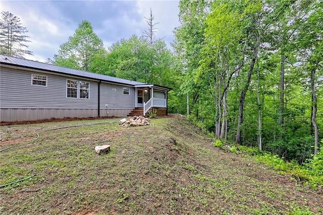 back of house with metal roof