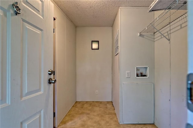 clothes washing area featuring washer hookup and a textured ceiling