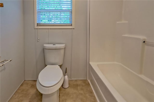 bathroom featuring toilet and baseboards