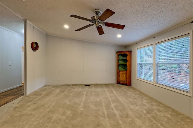 carpeted empty room featuring ceiling fan, ornamental molding, a textured ceiling, and recessed lighting