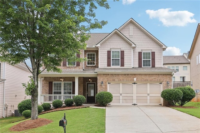 230 Collins View Ct, Lawrenceville, GA 30043 - craftsman house with concrete driveway, a porch, an attached garage, brick siding, and central AC unit