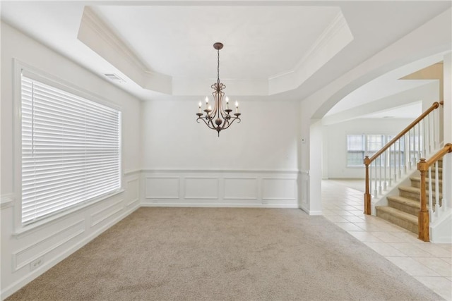 230 Collins View Ct, Lawrenceville, GA 30043 - unfurnished room with crown molding, arched walkways, light carpet, stairway, and a chandelier