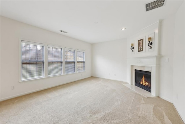 230 Collins View Ct, Lawrenceville, GA 30043 - unfurnished living room featuring a glass covered fireplace, light colored carpet, and baseboards