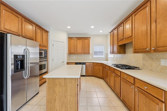 230 Collins View Ct, Lawrenceville, GA 30043 - kitchen with stainless steel appliances, a kitchen island, tasteful backsplash, light tile patterned flooring, and recessed lighting