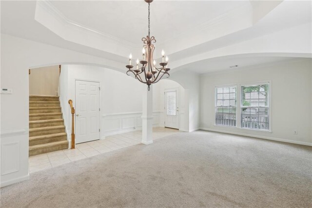 230 Collins View Ct, Lawrenceville, GA 30043 - carpeted empty room with arched walkways, ornamental molding, stairway, a chandelier, and a tray ceiling