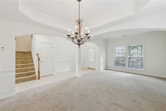 230 Collins View Ct, Lawrenceville, GA 30043 - carpeted spare room with arched walkways, crown molding, stairway, a chandelier, and a raised ceiling