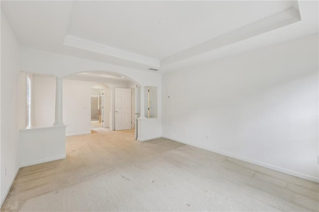 230 Collins View Ct, Lawrenceville, GA 30043 - empty room featuring a tray ceiling, arched walkways, light colored carpet, baseboards, and ornamental molding