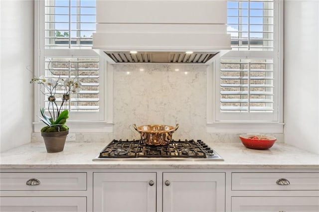 5971 Brundage Ln, Norcross, GA 30071 - kitchen featuring premium range hood, stainless steel gas stovetop, white cabinetry, and light stone counters