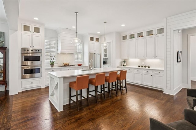 5971 Brundage Ln, Norcross, GA 30071 - kitchen featuring stainless steel appliances, tasteful backsplash, light countertops, a center island with sink, and recessed lighting