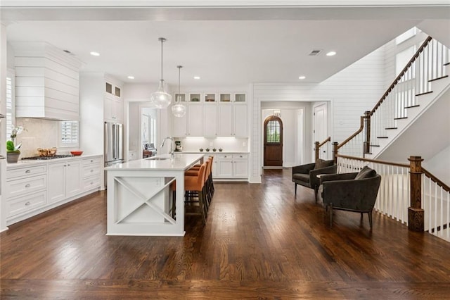 5971 Brundage Ln, Norcross, GA 30071 - kitchen featuring a sink, light countertops, dark wood-style floors, glass insert cabinets, and white cabinetry