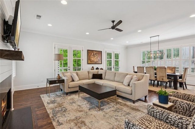 5971 Brundage Ln, Norcross, GA 30071 - living room with a warm lit fireplace, ceiling fan, crown molding, baseboards, and recessed lighting