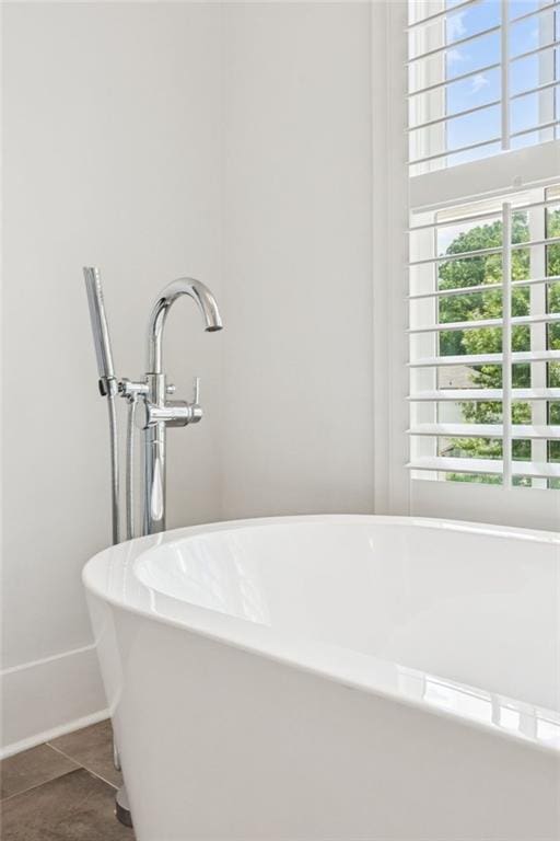 5971 Brundage Ln, Norcross, GA 30071 - bathroom with a freestanding bath, tile patterned floors, and baseboards