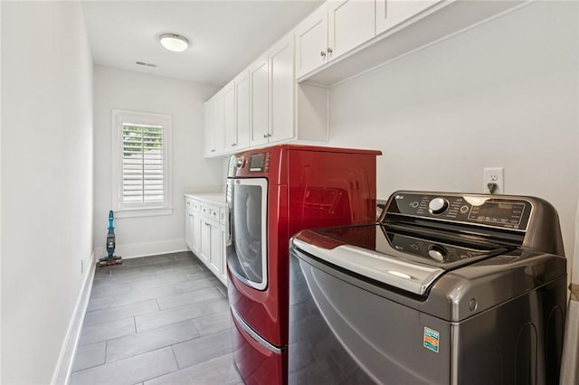 5971 Brundage Ln, Norcross, GA 30071 - washroom featuring washing machine and clothes dryer, cabinet space, baseboards, and tile patterned flooring