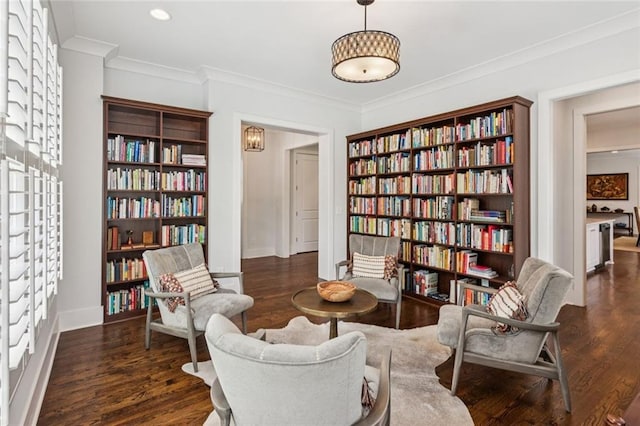 5971 Brundage Ln, Norcross, GA 30071 - sitting room with bookshelves, crown molding, wood finished floors, baseboards, and recessed lighting