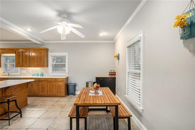 kitchen featuring a breakfast bar, decorative backsplash, a wealth of natural light, appliances with stainless steel finishes, and a kitchen island