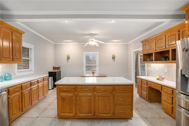 kitchen featuring a kitchen island, ceiling fan, stainless steel fridge with ice dispenser, light countertops, and brown cabinetry