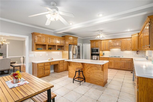 kitchen with tasteful backsplash, a breakfast bar, stainless steel appliances, ceiling fan, and a kitchen island