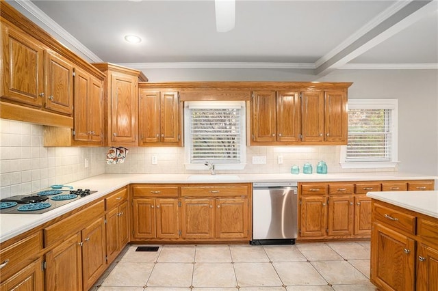 kitchen with a sink, light countertops, electric stovetop, stainless steel dishwasher, and a wealth of natural light