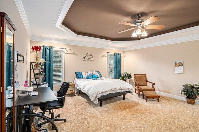 bedroom with carpet flooring, ceiling fan, a raised ceiling, and ornamental molding